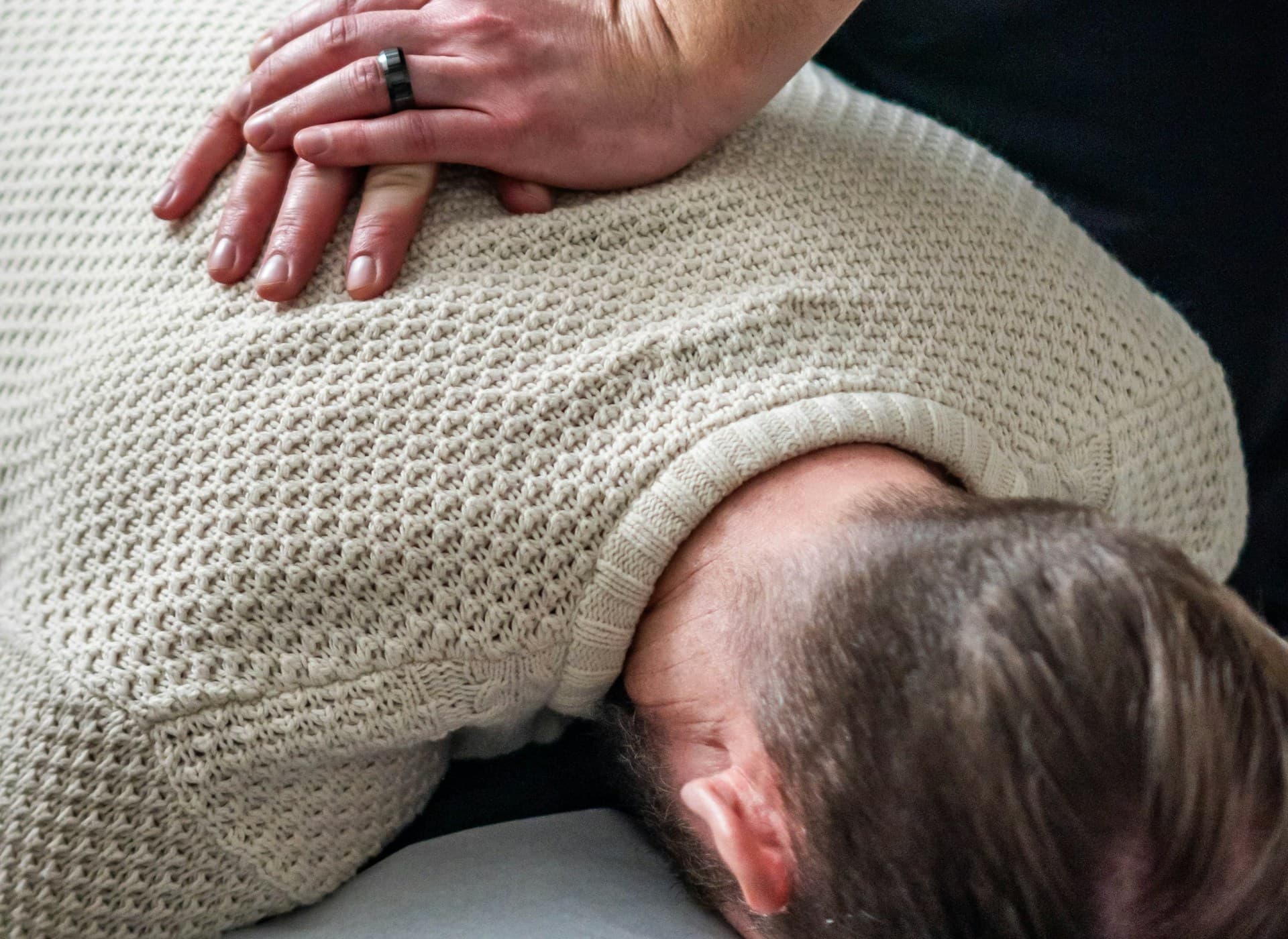 Chiropractor gently performing a spinal adjustment on a patient in a calm treatment room
