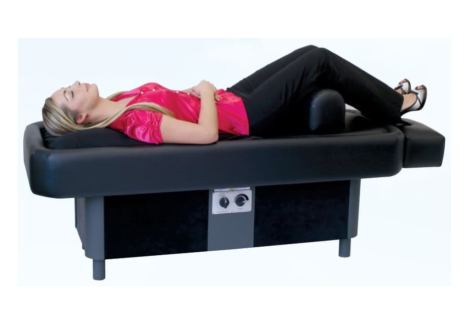Patient relaxing on a hydromassage bed during a warm water massage treatment