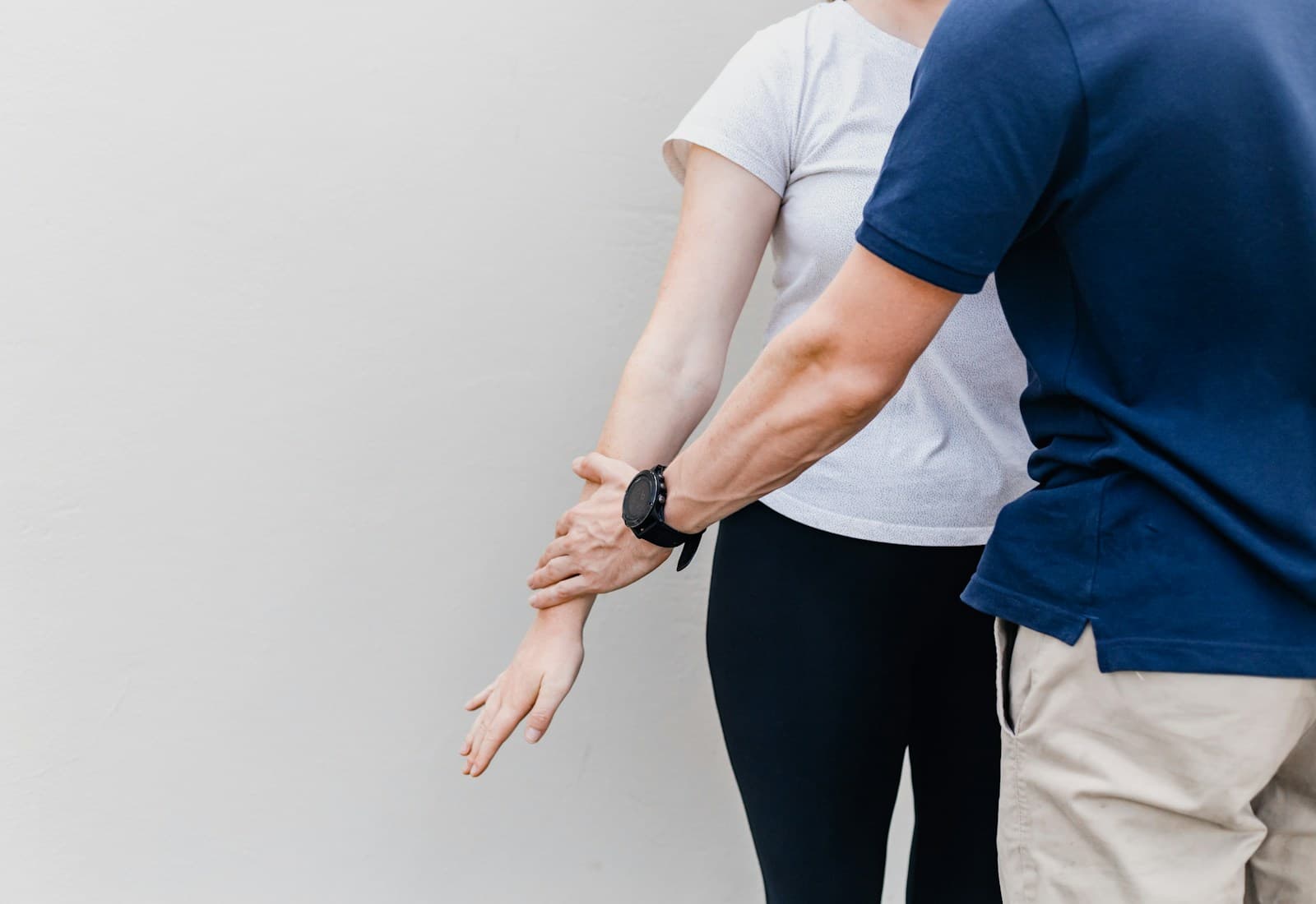 Chiropractor carefully assessing a patient's shoulder mobility during a consultation